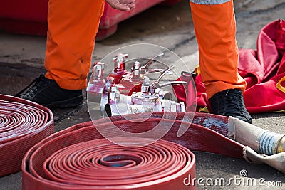 Rolled into a roll red fire hose, Fire equipment extinguishers r Stock Photo