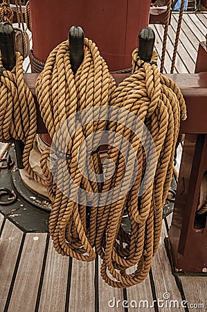 Rolled rope supported on the central mast of a sailing ship on a cloudy day in Amsterdam. Stock Photo