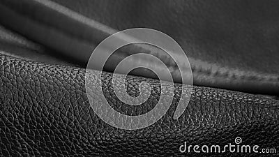 Rolled up black leather close up, abstract background, texture. Commercial and industrial concept. Selective focus Stock Photo