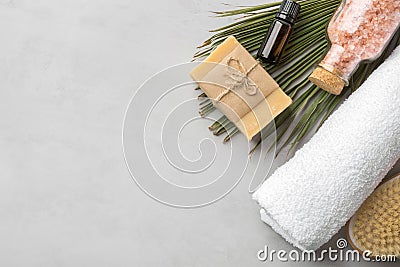 Rolled white pure cotton terry towel essential oil in amber glass bottle artisan handmade soap body brush pink Himalayan salt Stock Photo