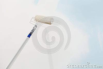 Roller brush painter isolated in white wall, painting concept Stock Photo