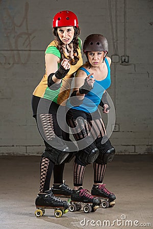 Roller Derby Skaters in Pointing Finger Stock Photo