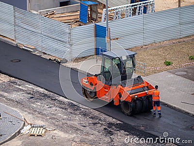 roller for leveling asphalt when laying the roadbed, road repairs, asphalting tracks, modern equipment for road Stock Photo