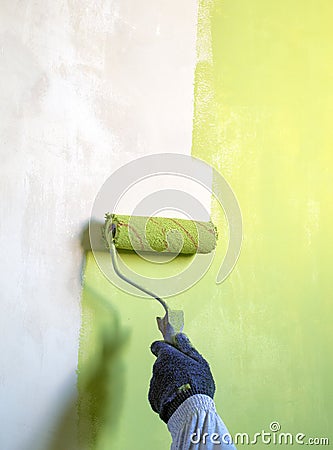 Roller for painting the walls green paint Stock Photo