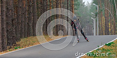 Roller skating sports girl in a helmet outdoors. Stock Photo