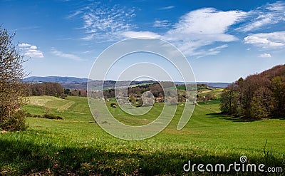 Rolling hills with green grass on spring day in Palatinate Forest Stock Photo