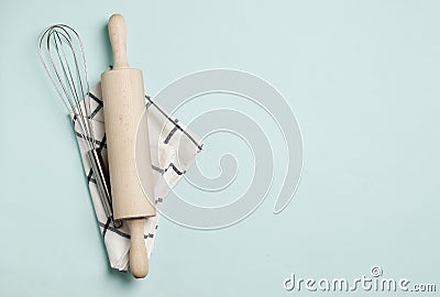 Rolling pin, whisk and dishcloth on a blue Stock Photo