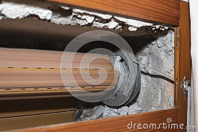 Rolling shutter repair, open box containing a broken roller shutter Stock Photo