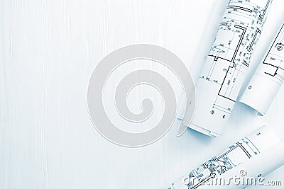 rolls of architectural plans and blueprints on architect workspace Stock Photo