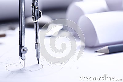 rolls of blueprints, drawing compass and graphical architectural plan Stock Photo