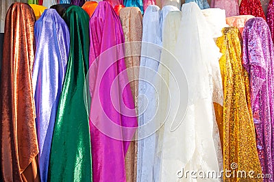 Rolls colorful of brightly coloured fabrics and cloths store Stock Photo