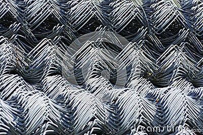 Rolls of galvanized steel wire mesh with a large cell and twisted pattern close-up. In the category of texture, screen Stock Photo