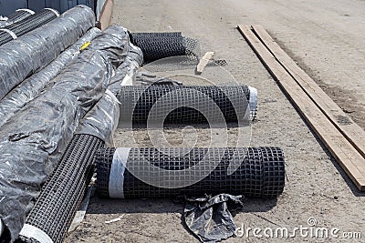 Rolls of geogrid for reinforcement the roadbed. Stock Photo