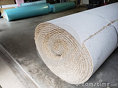 Rolls of new carpet in the garage of house for replace Stock Photo