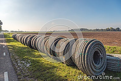 Rolls of new permeable pipes for the construction of a subsurface drainage system Stock Photo