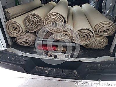 Rolls of old carpet in the truck for installation Stock Photo