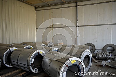 Rolls of steel sheet stored in warehouse; galvanized steel coil in the Duct Factory. Packed rolls of steel sheet, Cold rolled stee Editorial Stock Photo