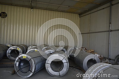 Rolls of steel sheet stored in warehouse; galvanized steel coil in the Duct Factory. Packed rolls of steel sheet, Cold rolled stee Editorial Stock Photo