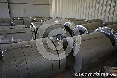 Rolls of steel sheet stored in warehouse; galvanized steel coil in the Duct Factory. Packed rolls of steel sheet, Cold rolled stee Editorial Stock Photo