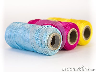 Rolls of thread with CMYK colors. Stock Photo