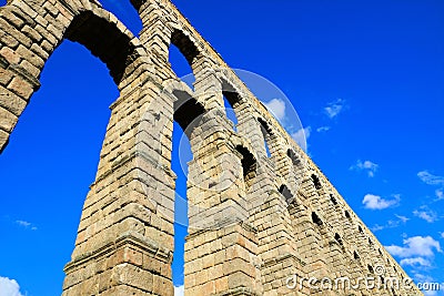 Roman Aqueduct of Segovia, Spain under blue skies Stock Photo