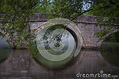 Roman bridge reflection on river Bosna in Sarajevo Stock Photo