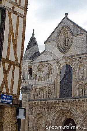 Roman church of Poitiers, France and half-timbered street house Stock Photo