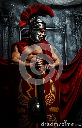 Roman good shaped warrior holds sword and schield Stock Photo