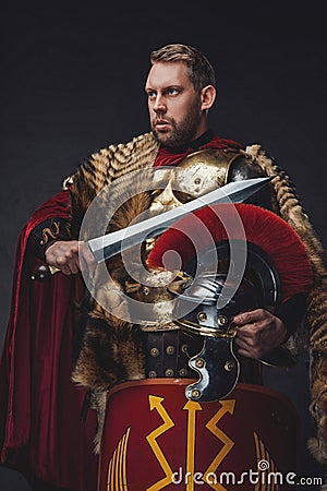 Roman legionnaire in bronze armor with gladius Stock Photo