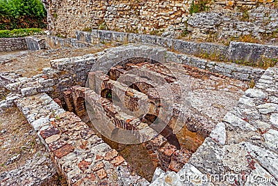 Roman ruins of Conimbriga. Hypocaust structure used to heat the water of the Caldarium room in the Roman Baths of the Wall. Stock Photo