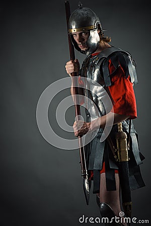 Roman soldier in armor with a spear in hand Stock Photo