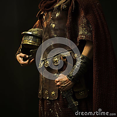 Roman soldier with his armor and with black background Stock Photo