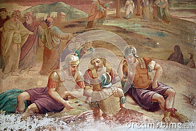 Roman soldiers playing dice about things of Jesus Christ - old mural painting Editorial Stock Photo