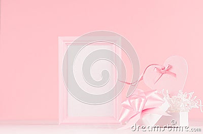 Romance celebration mockup for Valentine and wedding - cute heart with silk ribbon, gift and blank frame for text on white wood. Stock Photo