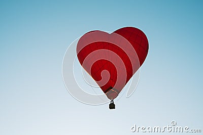 The romance of flying in a balloon in the shape of a red heart Stock Photo