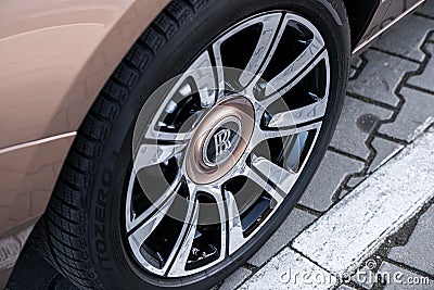 Detail view of a Rolls Royce Ghost rim painted in light gold color Editorial Stock Photo