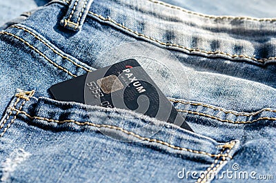 Romania -May 17,,2020 : Paxum plastic card in the back pocket of jeans . Concept of savings, during the financial crisis or card Editorial Stock Photo