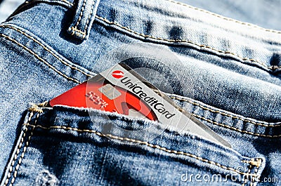Romania -May 17,,2020 :UniCredit plastic card in the back pocket of jeans . Concept of savings, during the financial crisis or Editorial Stock Photo