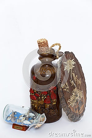 Edelweiss flowers from Predeal city, Sand and shells from Black Sea and bottle of tuica from Bran city Stock Photo