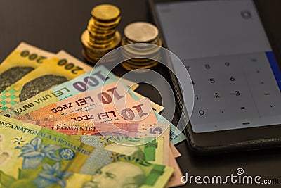 Romanian currency LEI on black background with mobile calculator. Money, tax, news concept Stock Photo