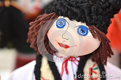 Portrait of the original handmade male doll with big blue eyes wearing traditional Romanian style clothes Stock Photo