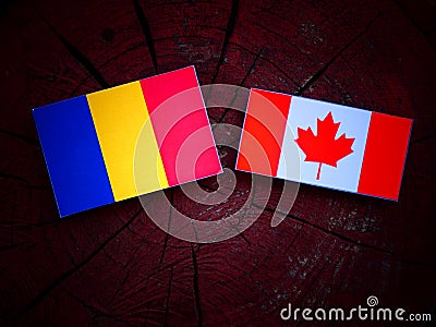 Romanian flag with Canadian flag on a tree stump isolated Stock Photo