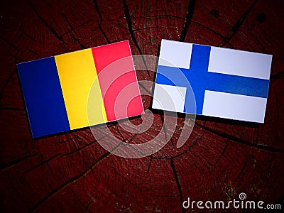 Romanian flag with Finnish flag on a tree stump isolated Stock Photo