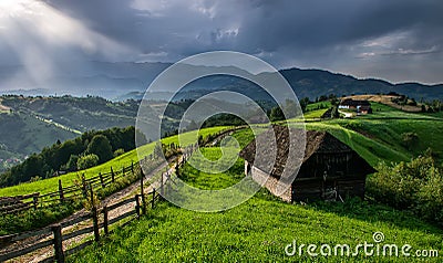 Romanian hillside and village in summer time , mountain landscape of Transylvania in Romania Stock Photo