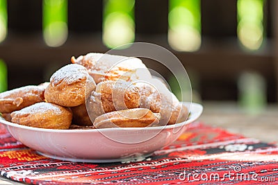 Romanian mini doughnuts on a plate on red traditional cloth Stock Photo