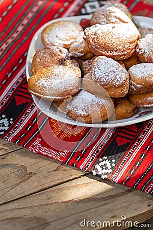 Romanian mini doughnuts on a plate on red traditional cloth Stock Photo