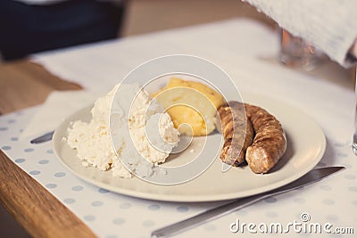 Romanian polenta dish with cheese and sour cream Stock Photo