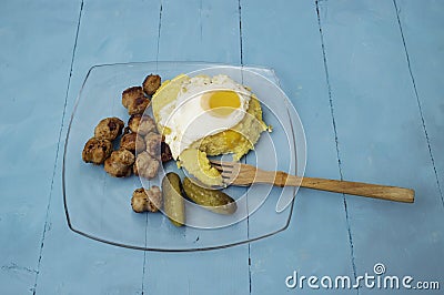 Romanian traditional food, fried sausages, soft egg and "mamaliga Stock Photo
