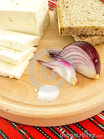 Romanian traditional snack of cheese onion and bread on a wooden plate Stock Photo