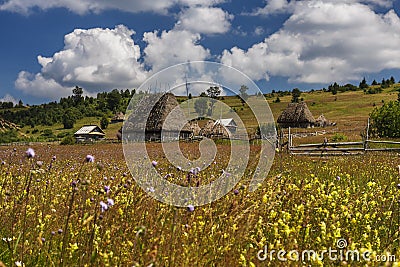 Romanian traditional village with old barn or shack with straw roof Stock Photo